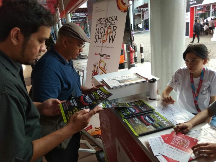 Pengunjung antusias membaca Mobilinanews Magazine edisi khusus IIMS 2018. (foto : anto)