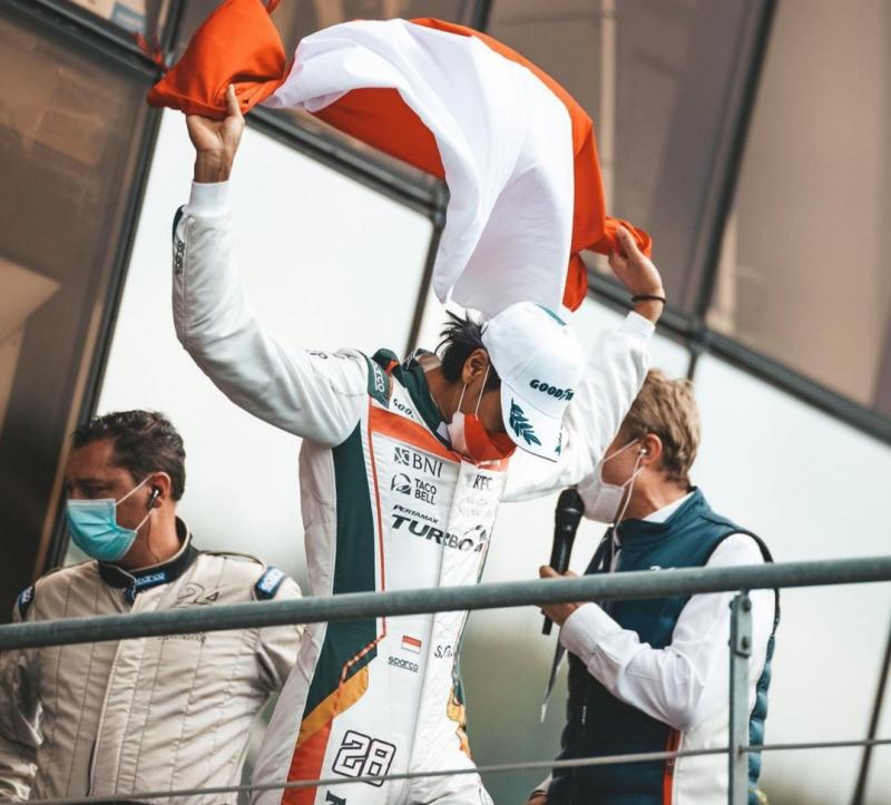 Sean Gelael naik podium dengan membentangkan bendera Merah Putih di podium 24 Hours of Le Mans 2021